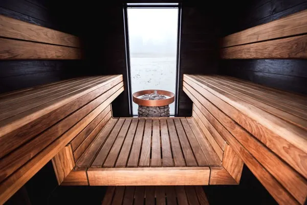 Sauna interior with a view of an icy lake through the window
